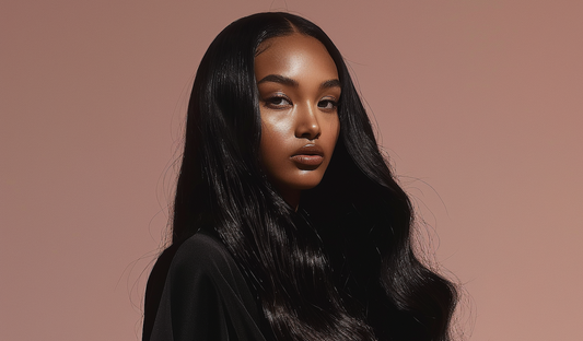 a beautiful black woman wears super double drawn vietnamese hair wig. she looks directly at the camera, with a subtle dusty pink gradient background behind her